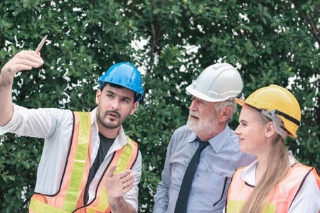 Construction Engineer Team Discussion Planing Work for Residential Estate Project, Engineering Teamwork Meeting Discuss About Building Architecture at Construction Site Together. Business Contractorの写真素材