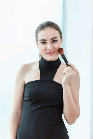 Beauty Face Skin Care and Makeup Cosmetic, Closeup Portrait of Pretty Woman in Sexy Fashion With Happy Smile and Powder Brush. Facail Cosmetology Make-Up Brush Applying for Beauty Perfect Healthy Skinの写真素材