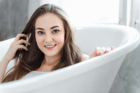 Portrait of Pretty Woman Relaxing in a Bathtub, Close-Up of Caucasian Woman Happiness and Relaxed in...