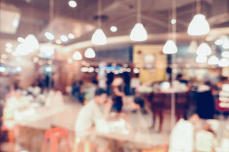 Abstract Motion Blur in Department Store, Defocused Blurry of Restaurant Shop and People Crowded in Shopping Mall. Bokeh Blurred Scene Inside Coffee Cafe and Food Court Centerの写真素材