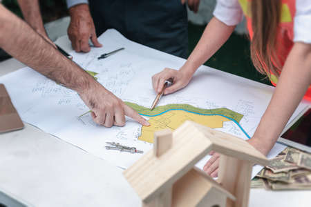 Construction Engineers Team Discussion and Brainstorming Meeting for Project Planning Together, Engineering Teamwork in Safety Equipment Discussing Conference Agreement Together at Site Erection.の写真素材