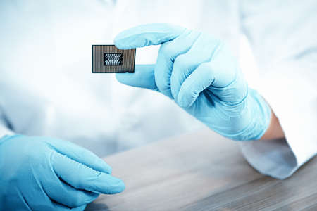 Electronic Lab Science and Manufacturing Computer Processor Concept, Engineer CPU Microchip Development Holding Circuit CPU for Examination Damage in Laboratory. Engineering Microprocessor Motherboardの写真素材