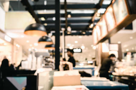 Abstract Motion Blur in Department Store, Defocused Blurry of Restaurant Shop and People Crowded in Shopping Mall. Bokeh Blurred Scene Inside Coffee Cafe and Food Court Centerの写真素材
