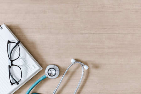 Top View of Doctor Workspace With Stethoscope and Personal Equipment on Table Desk, Above View of Doctor Working Space at Clinic Hospital. Health Medical Occupation and Business Healthcare Conceptの写真素材