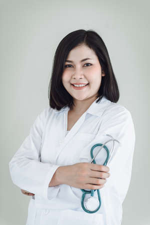 Healthcare Medical Consulting Concept, Female Medicine Doctor With Holding Stethoscope Standing Against Isolated Background. Business Health Consultation Hospital and Medical Disease Checkupの写真素材