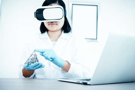 Laboratory Research Scientist and Science Innovation Concept, Female Scientists Analyzing Chemical Structure via Virtual Reality Glasses Technology. Professional Chemist Working Experiment in Labの写真素材
