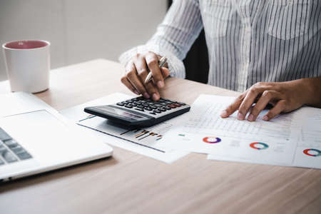 Business Accountant Woman Analysis Finance Accounting Budget Report at Her Office Desk. Professional Financial Manager Planning to Strategy and Account Cost Saving for Company Project Investment.の写真素材