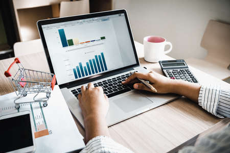 Business Accountant Woman Analysis Finance Accounting Budget Report at Her Office Desk. Professional Financial Manager Planning to Strategy and Account Cost Saving for Company Project Investment.の写真素材