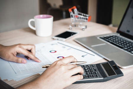 Business Accountant Woman Analysis Finance Accounting Budget Report at Her Office Desk. Professional Financial Manager Planning to Strategy and Account Cost Saving for Company Project Investment.の写真素材