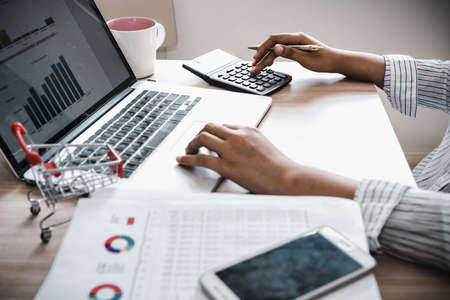 Business Accountant Woman Analysis Finance Accounting Budget Report at Her Office Desk. Professional Financial Manager Planning to Strategy and Account Cost Saving for Company Project Investment.の写真素材