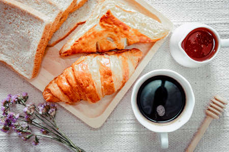 Hot Coffee Cup With Croissant Baked for Breakfast, Fresh Bread With Coffee Espresso on Table Cafe Shop. Homemade Freshness Baked Whole Wheat Bread and Hot Coffee for Health in The Morning Breakfast.の写真素材