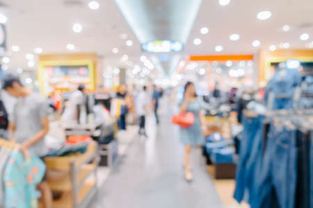 Defocus Abstract Motion Blur in Shopping Mall, Blurry Crowded Image of People in Department Store Shop. Defocused Interior With Bokeh Light in Shop Retail Store, Abstract Background Conceptの写真素材
