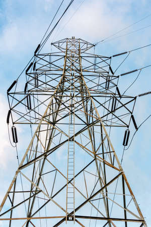 High Voltage of Electricity Power Transmission Line Tower for Distribution to Substation, Structure Steel of Energy Power Electrical Cable Pole. Transmission High Voltage of Power Line Cables Network.の写真素材