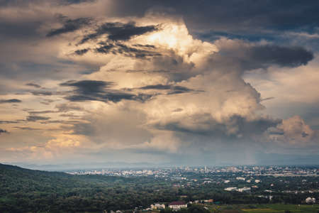 Landscape of Dramatic Cloudy Sky Over The City at Chiang Mai of Thailand, Stormy Atmosphere Weather Situation With Dramatic Clouds Sky at Evening Sunset. Natural Cloud Sky background.の写真素材