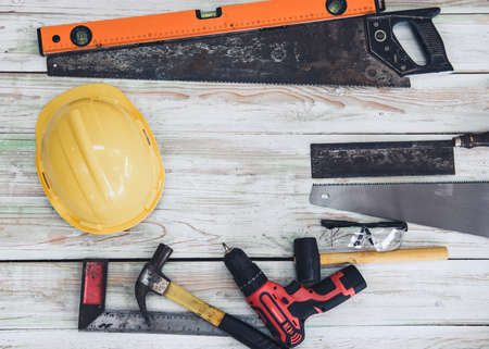 Home Maintenance and DIY Tool Work, Safety Equipments and Hand Tools for Home DIY Wooden Work on Table Wood Background. Carpentry Utility Tools for Building Repair and Wooden Hand Craftの写真素材