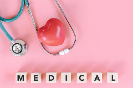 Medical Checkup and Health Insurance Concept, Stethoscope With Text "Medical" on Isolate Pink Background. Doctor Appointment Calendar for Medical Examination Banner Background. Healthcare and Medicineの写真素材