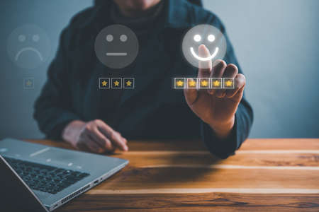 Customer Survey Feedback and Satisfaction Service Concept. Woman's Hands is Choosing Rate of Satisfaction Evaluation for Customers Service. Product Questionnaire for Customer Satisfied Feedback.の写真素材