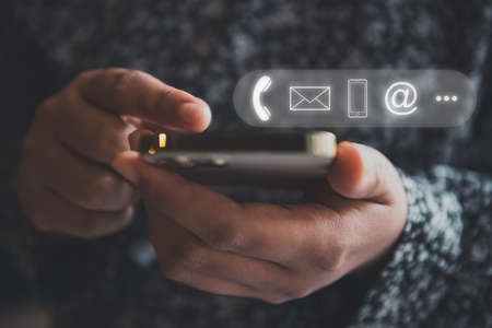 Contact Us Support Service and Information Connect Concept, Female's Hands is Using Mobile Phone and Laptop for Corporate Information Contact Via Email Support. Customer Communication Contact Servicesの写真素材