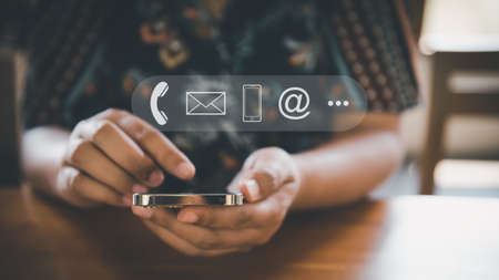 Contact Us Support Service and Information Connect Concept, Female's Hands is Using Mobile Phone and Laptop for Corporate Information Contact Via Email Support. Customer Communication Contact Servicesの写真素材