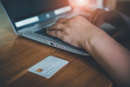 Business Credit Banking and Online Shopping Service, Close-Up of Business Woman Hands Using Credit Card for Paying Online Shopping on E-Commerce Web in Coffee Shop. Shopping Payment Via Credit Cardの写真素材