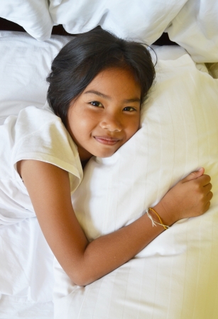 smiling girl on the bedの写真素材