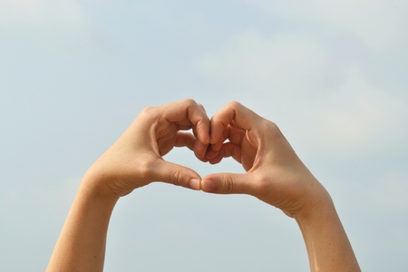 Love hand sign with heart shape with natural backgroundの写真素材