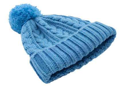 Close-up of a blue knitted winter hat with a pompom. The hat is soft and warm, perfect for cold...