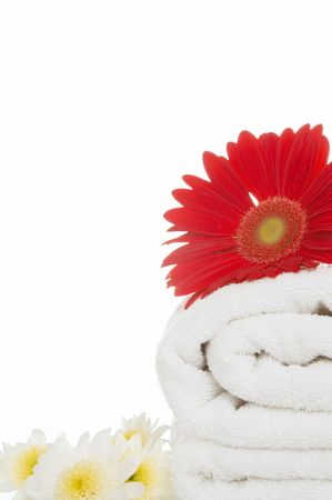 wellness concept with towel and daisy flower on whiteの写真素材