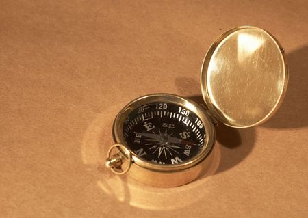 old golden compass on paper background, space for your messagesの写真素材