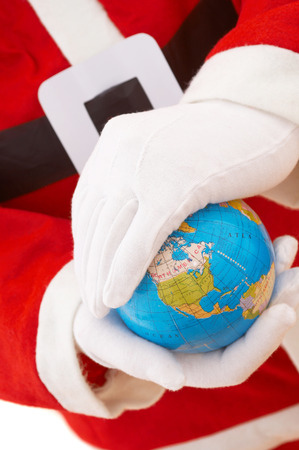 Santa claus protecting mini world, shallow dof, focus on worldの写真素材