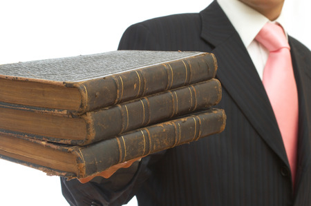 businessman holding old books on white backgroundの写真素材