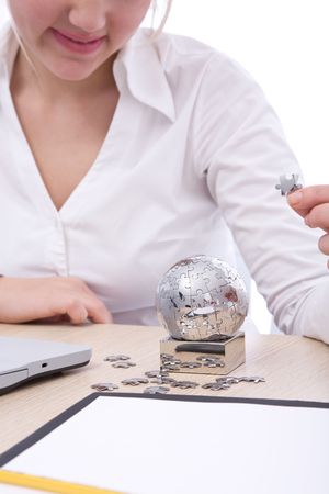 businesswoman with globe puzzle at the officeの写真素材