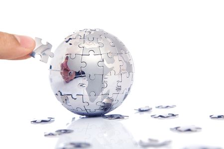 business concept with a hand building puzzle globe on white, space for messages