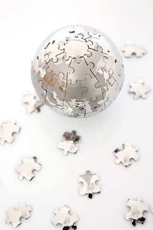 metalic globe puzzle with lots of piecesの写真素材