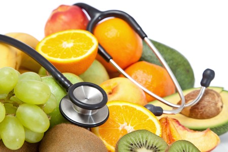 healthy fruits concept with stethoscopeの写真素材