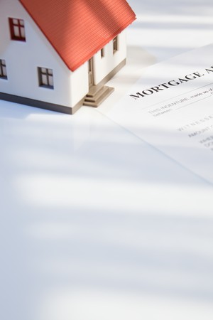 mortgage application form with a mini house for real estateの写真素材