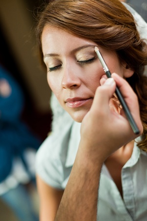 bride having a pro make up before weddingの写真素材