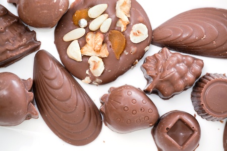 lots of different chocolates close up on white
