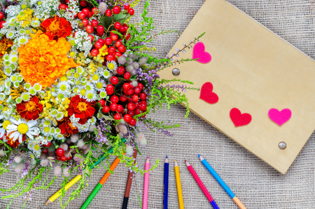 Boxes for gifts with flowers and notebook with pencils and paper heartの写真素材