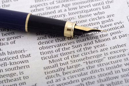 Pen over newspaper close upの写真素材