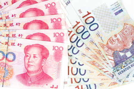 China Ren Ming Bi (RMB) versus Ringgit Malaysia (RM) in plain white background.の写真素材