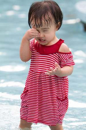 Chinese Little Girl Playing in Water in Swimming Poolの写真素材