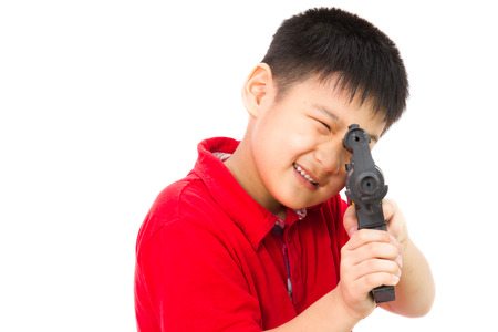 Asian Little Boy Playing Plastic Toy AK47 on White Backgroundの写真素材