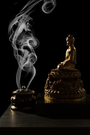 Sitting Bronze Budda with Incense Burner in isolated Black Backgroundの写真素材