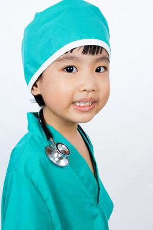 Asian Little Chinese Girl Playing a Doctor with Stethoscope in isolated White Backgroundの写真素材