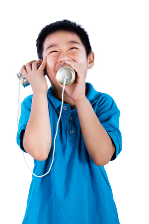 Asian Chinese Boy Playing with Tin Can Phone isolated on White Backgroundの写真素材