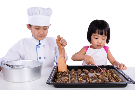 Asian Chinese Kid Baking Cookies in isolated white backgroundの写真素材