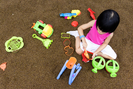 Asian Chinese Little Girl Playing with sand at indoor playgroundの写真素材