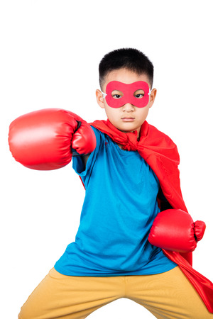 Asian Chinese boy wearing super hero costume with boxing gloves in isolated plain white background.の写真素材