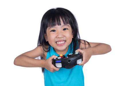 Asian Chinese little girl playing game with controller in isolated white background